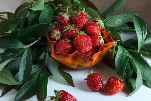 Ripe red strawberries. Berry in a orange vase