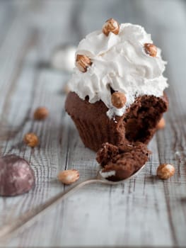 Delicious chocolate brownie muffins with nuts and whipped cream