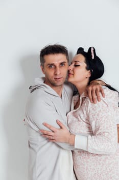 woman and man in pajamas in a bright room on a white background husband and wife lovers