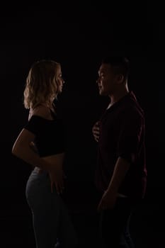 male and female dancers dance bachata kazimba latina in a dark room