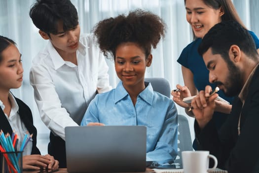 Happy diverse business people work together, discussing in corporate office. Professional and diversity teamwork discuss business plan on desk with laptop. Modern multicultural office worker. Concord