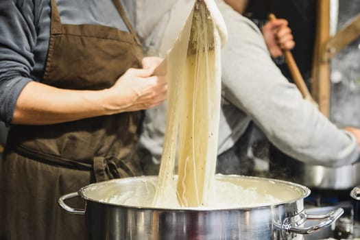 Baker kneads dough on the market The dough winds on a stick