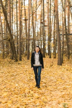 Outdoor atmospheric lifestyle portrait of young beautiful young woman copy space. Warm autumn fall season. Millennial generation and youth.