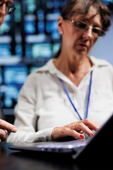 Cloud computing business executives working to maintain uptime in high tech space. Seasoned professionals brainstorming solutions to data center supercomputers crashing, trying to fix components