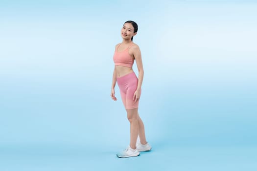 Full body asian woman in sportswear portrait, smiling and posing cheerful gesture. Workout training with attractive girl engage in her pursuit of healthy lifestyle. Isolated background Vigorous