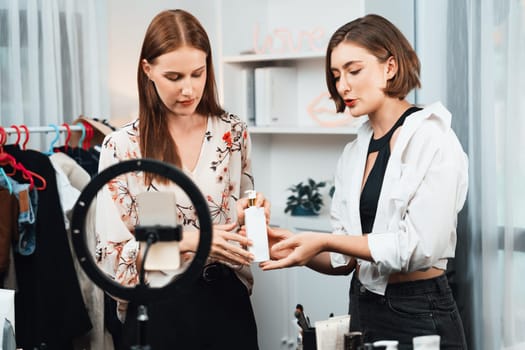 Woman influencer shoot live streaming vlog video review makeup utmost social media or blog. Happy young girl with cosmetics studio lighting for marketing recording session broadcasting online.