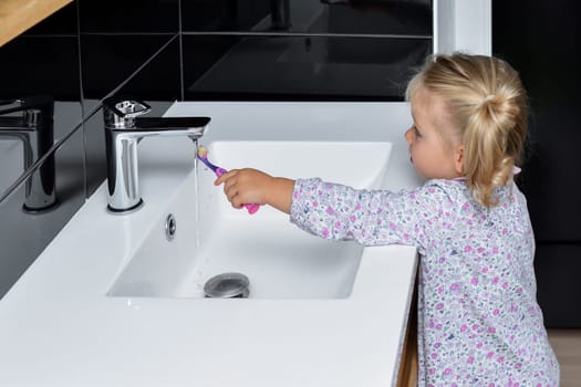 Little girl brushing teeth in the bathroom