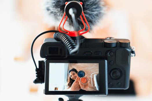 Asian Woman influencer shoot live streaming vlog video review makeup uttermost social media or blog. Happy young girl with cosmetics studio lighting for marketing recording session broadcasting online