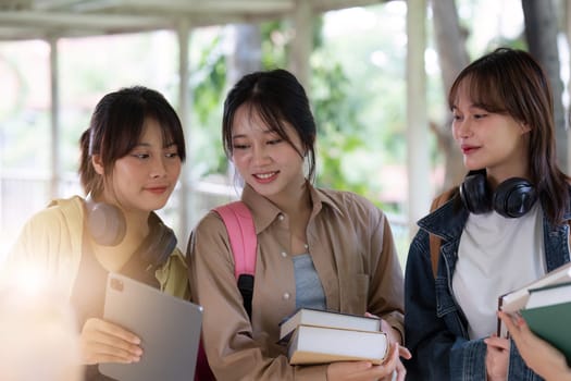 Group of Young Asian student walking and talking at university before class room. education, back to school concept.