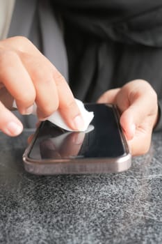 man hand cleaning mobile phone display