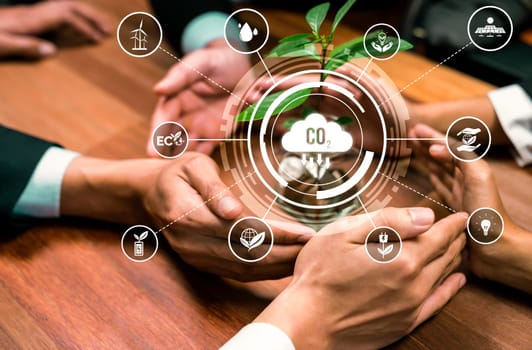 Business partnership nurturing or growing plant together with carbon icon symbolize ESG sustainable environment protection with eco technology and carbon credit solution for net zero future. Reliance