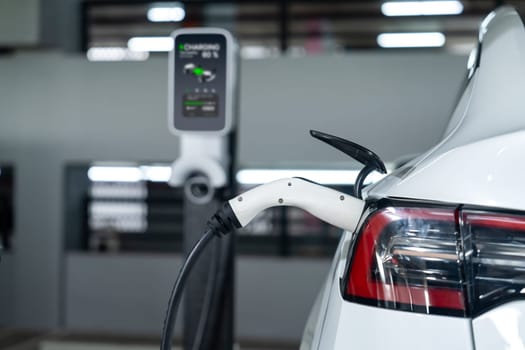 EV electric car recharge at shopping center parking lot charging in downtown city showing urban sustainability lifestyle by green clean rechargeable energy of electric vehicle innards