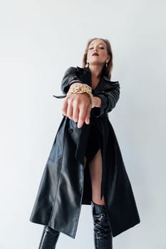 woman in a black cloak with an outstretched arm on a white background