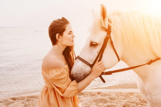 A white horse and a woman in a dress stand on a beach, with the sky and sea creating a picturesque backdrop for the scene