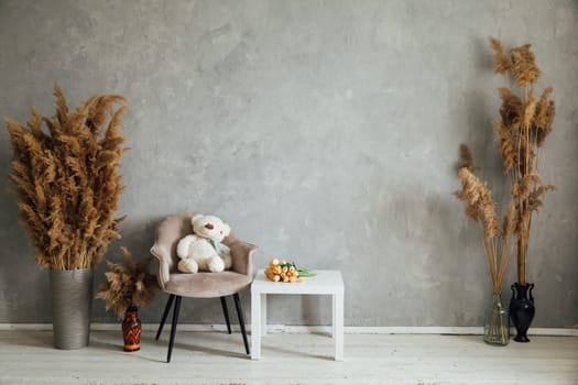 an Interior in the room table chair with toy decorative flowers