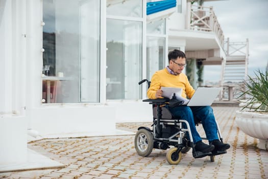 person with disabilities near the building with a laptop