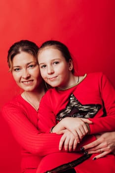 a mother and daughter family on a red background