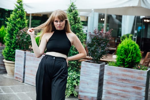 beautiful woman standing near a restaurant walk