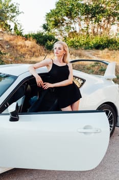 a woman blonde standing near white car travel driving driver