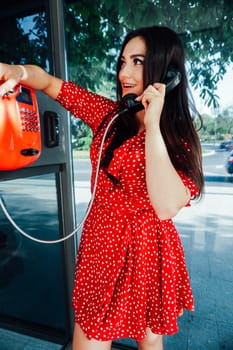 woman in a phone booth talking on the phone