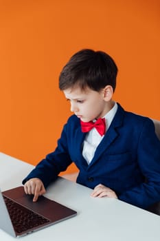 a boy at the computer in the classroom learning online school IT programming