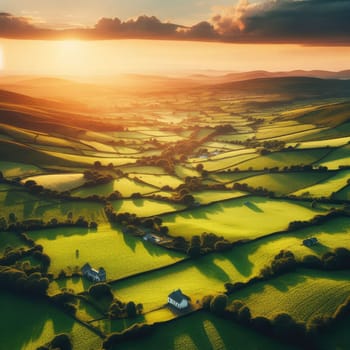 Aerial view of endless lush pastures and farmlands of Ireland. Beautiful Irish countryside with emerald green fields and meadows. Rural landscape on sunset.