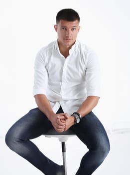 Young successful businessman on a white background in a shirt