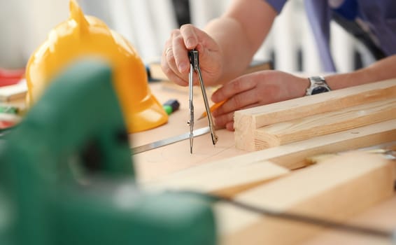 Arms of worker making structure plan on scaled paper closeup. Manual job DIY inspiration improvement job fix shop graphic joinery startup workplace idea designer career wooden bar ruler