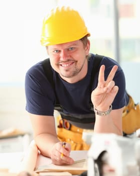 Smiling funny worker in yellow helmet posing. Manual job workplace DIY inspiration improvement fix shop hard hat joinery startup idea industrial education profession career concept