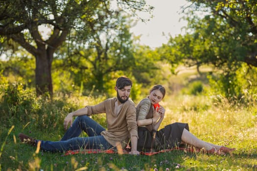 Young couple in nature, a girl with a phone is texting someone