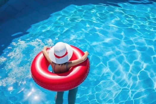 Christmas holidays on tropical destinations. woman in Santa Claus hat with inflatable ring relaxing in blue swimming pool. AI Generated