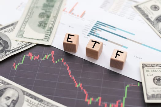 ETF financial business concept. Wooden cubes and paper dollar bills as a background. High quality photo