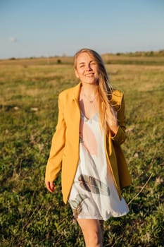 a walking journey a blonde woman walking in nature on green grass in a field