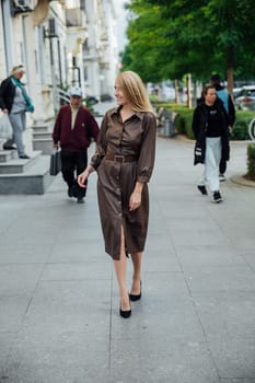 a blonde woman walks down the street walking rest pedestrian