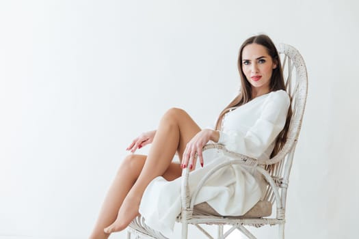 beautiful woman sitting in a chair in bright fashion room