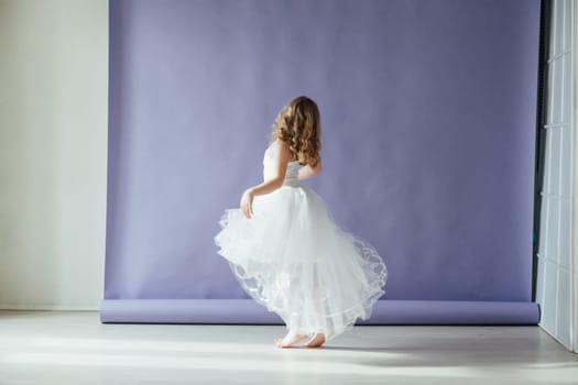 girl dancing in the studio in beautiful dance dress