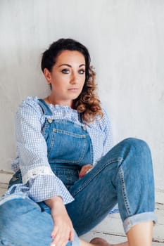 woman sitting by a net in a bright room on a white background