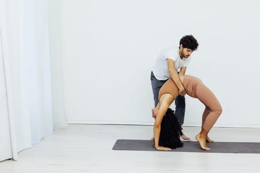 a man and woman do gymnastics warm-up yoga asana posture exercises