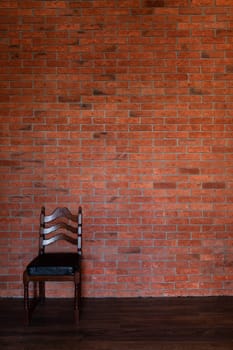 a chair against the brick wall in the room pieces of furniture