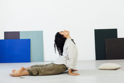 a stretching woman doing yoga lotus pose exercises relaxation classes