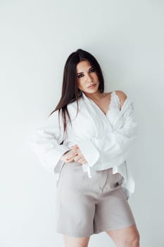 a beautiful brunette woman in a bright room on a white background