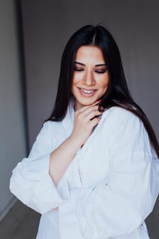 a portrait of a beautiful brunette girl in white clothes