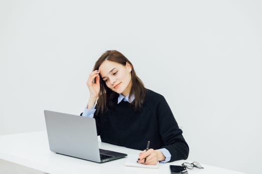 a woman at the computer in the office remote work internet conversation online