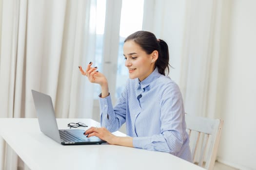 a woman communicates via skype with laptop at remote work internet conversation online communication