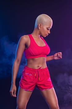 Sporty fit woman, athlete with dumbbells make fitness exercises on black background. Download cover for music collection for fitness classes. Sports recreation. Beautiful black young woman.