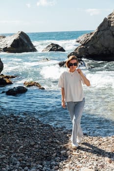 woman walks along the seashore holiday beach sea