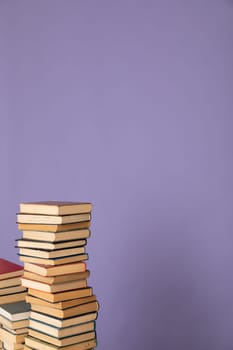 stack of books in the library on a purple background training education science