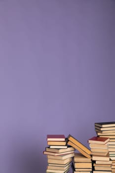 stack of books in the library on a purple background training education science