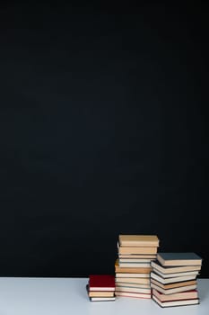 stack of books in the library on a black background training education science