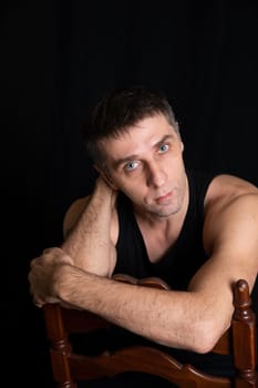 portrait of a man in dark room on a black background